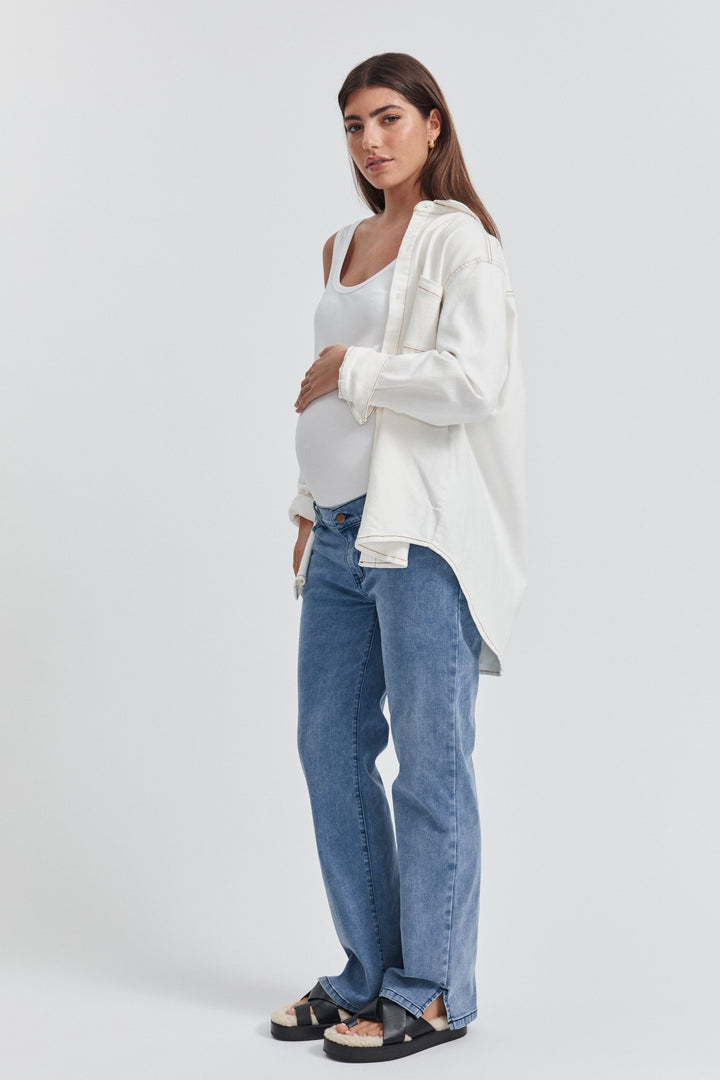 Pregnant model wearing the perfect Maternity jeans by Legoe Heritage. Style with a white Cotton Rib Bodysuit and White Denim Shirt slung over the top